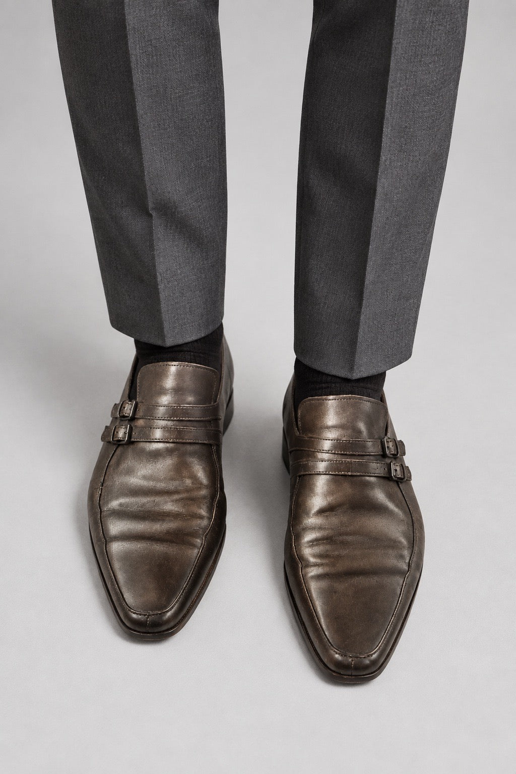 Bottega Veneta chaussures double boucle en cuir brun portées avec un pantalon noir — Seconde Main VestiaireFMR